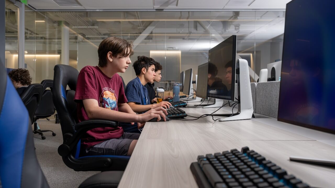 Three students focused on their computers
