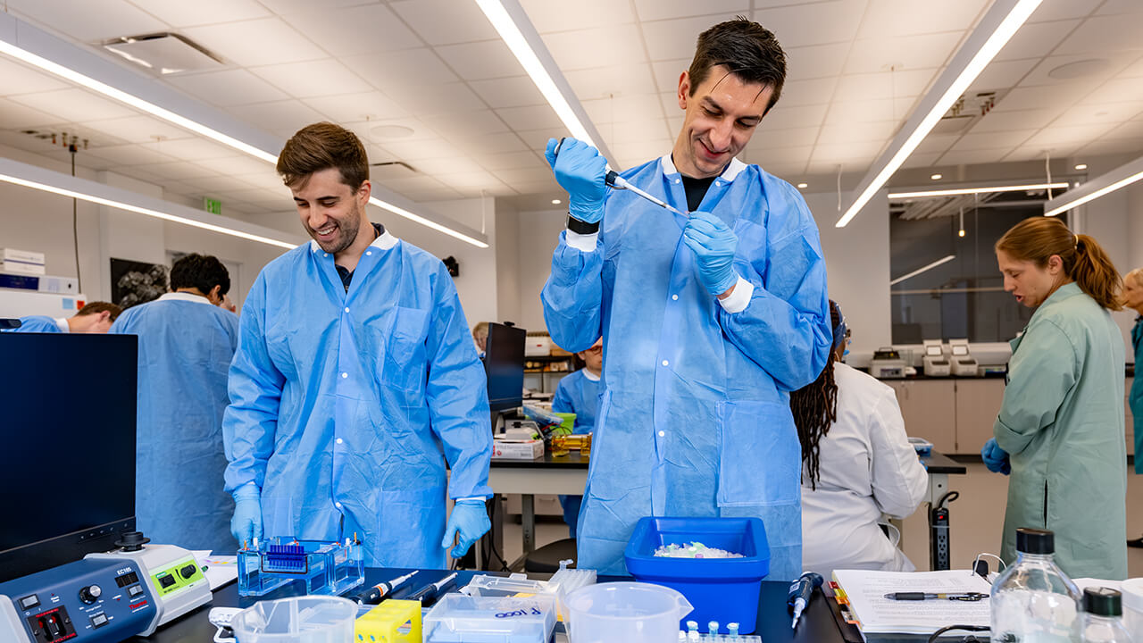Lab participants pipetting into tubes