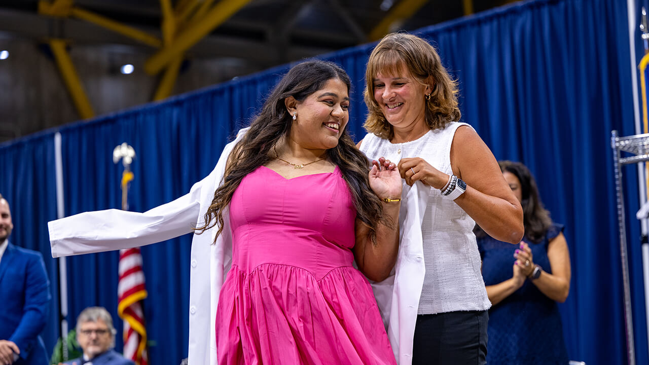 Student presented with white coat