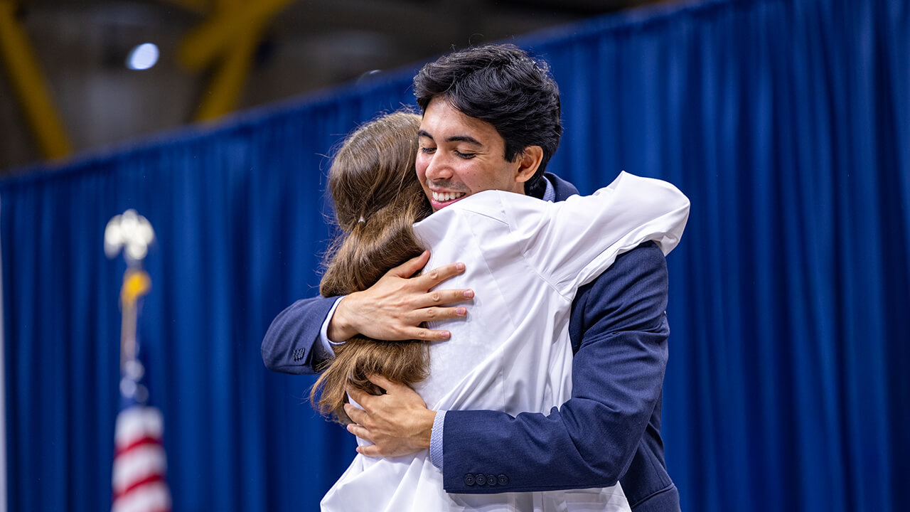 Student and family member hugging