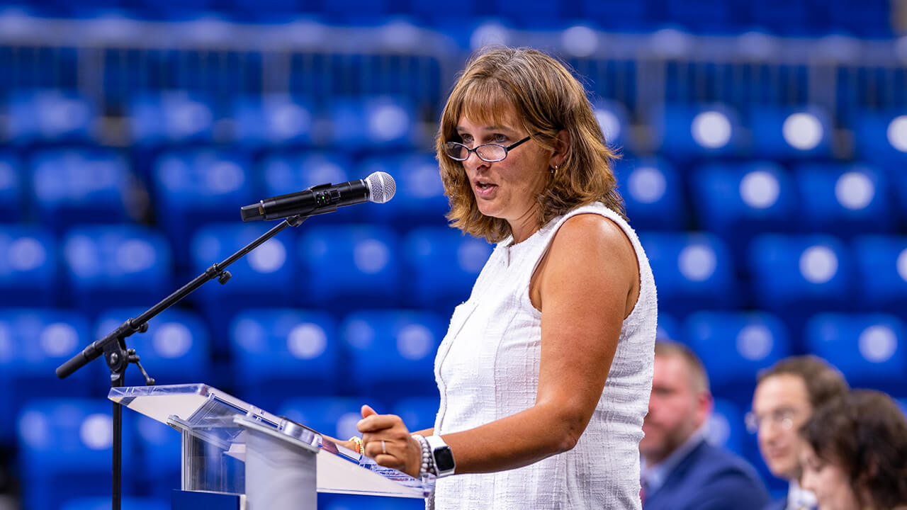 Faculty speaking at the podium