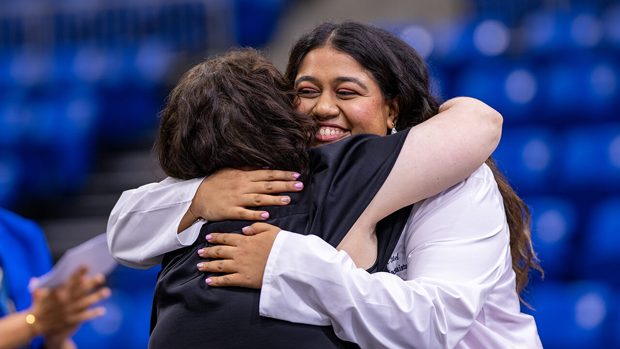 Student hugging a family member