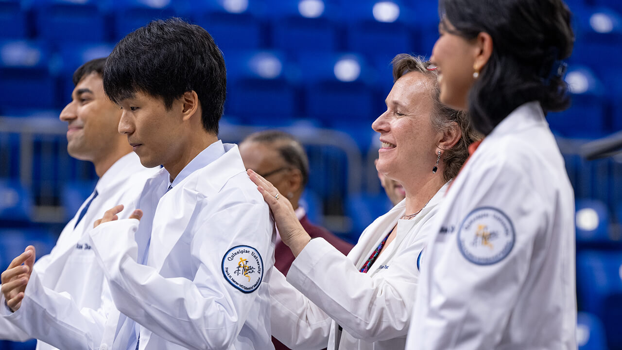 Students presenting with their white coats