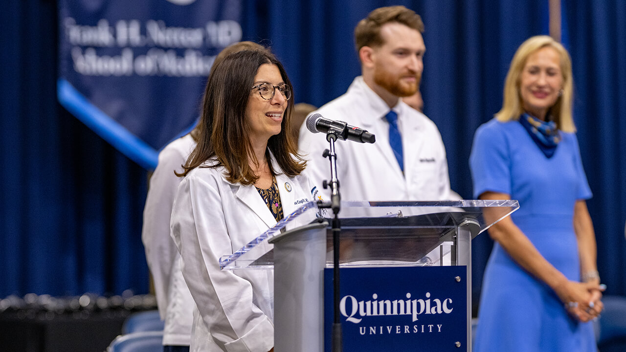 Dean speaking at podium