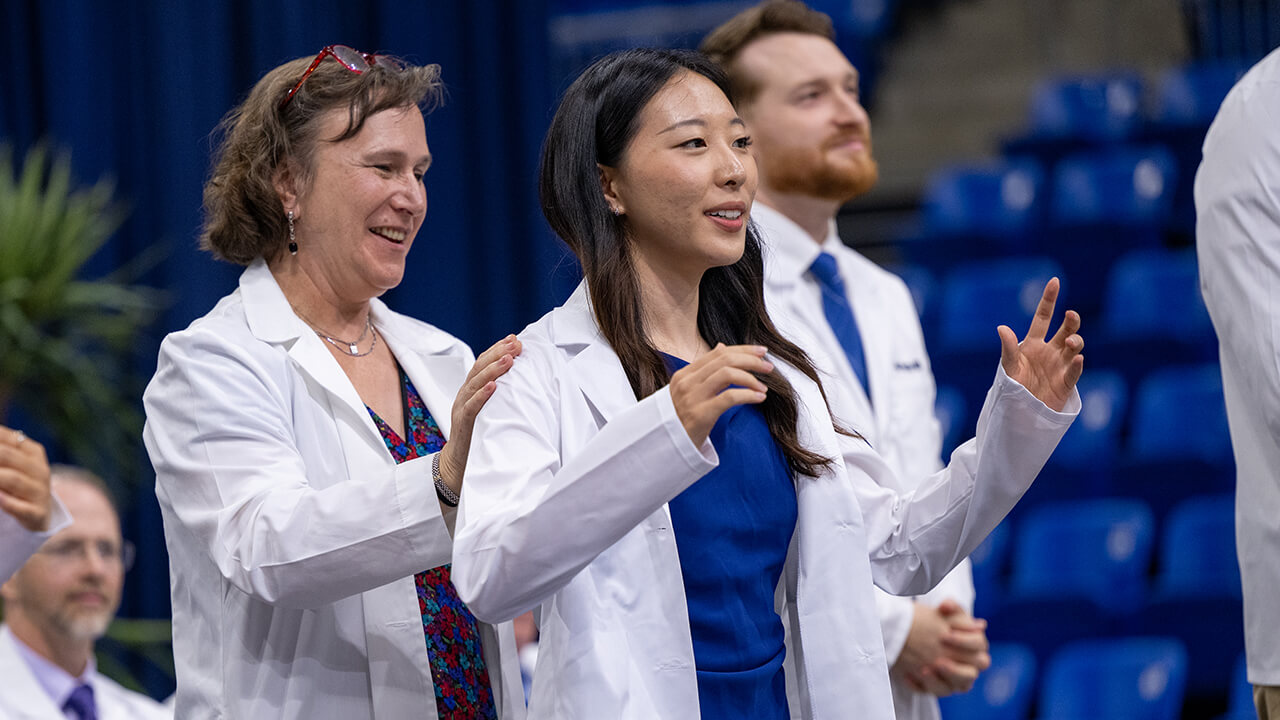 Student presented with white coat