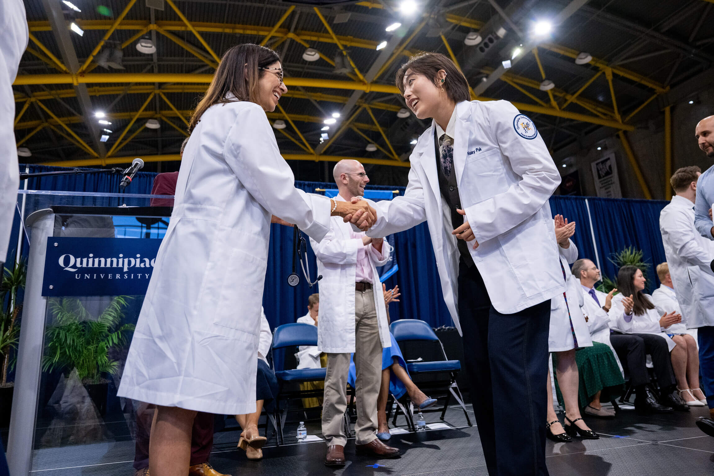 Haley Pak, MD '30, shaking Dean Coplit's hand