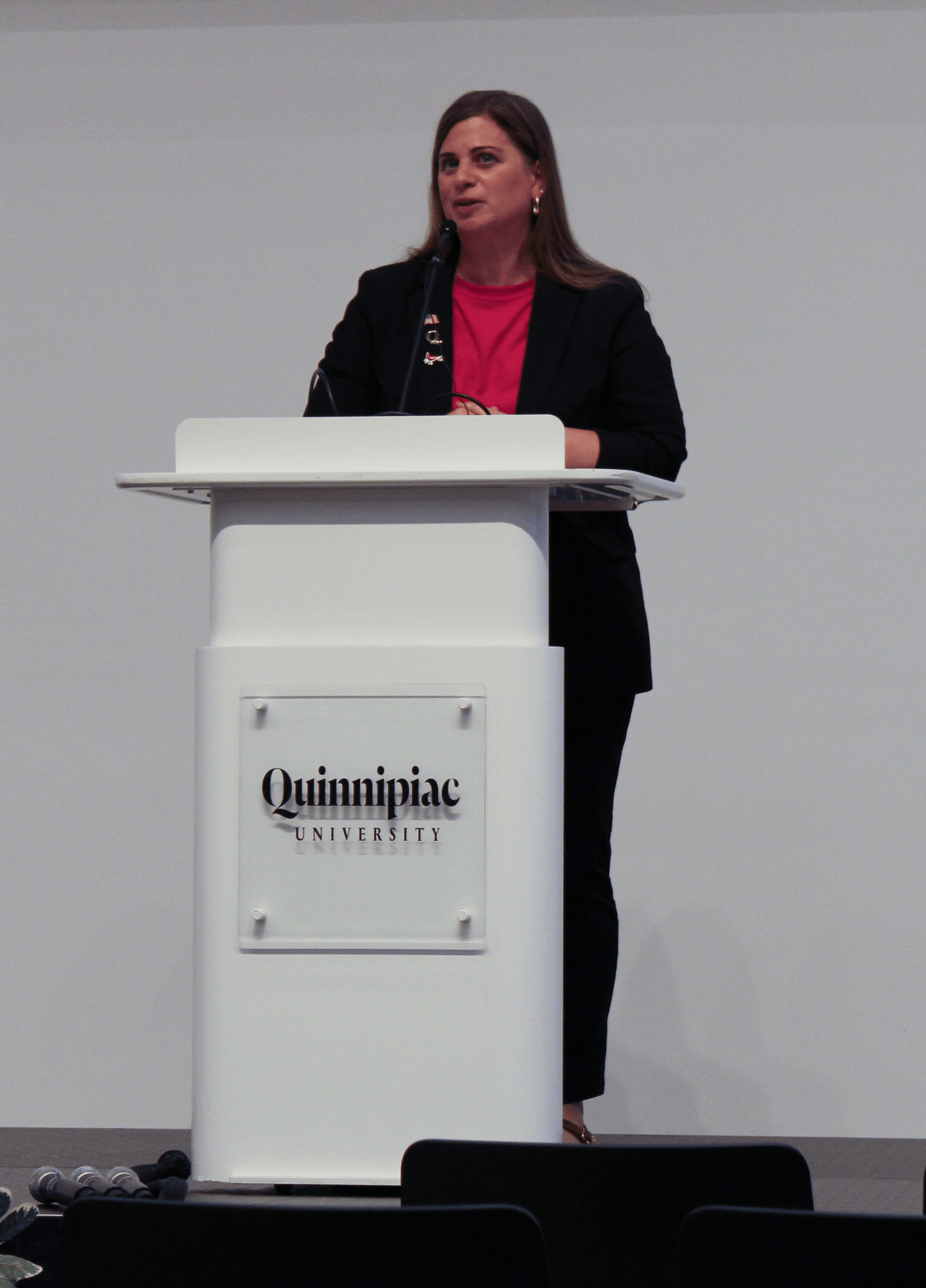Karla Natale speaks at the Quinnipiac podium during the 9/11 Teach-In.